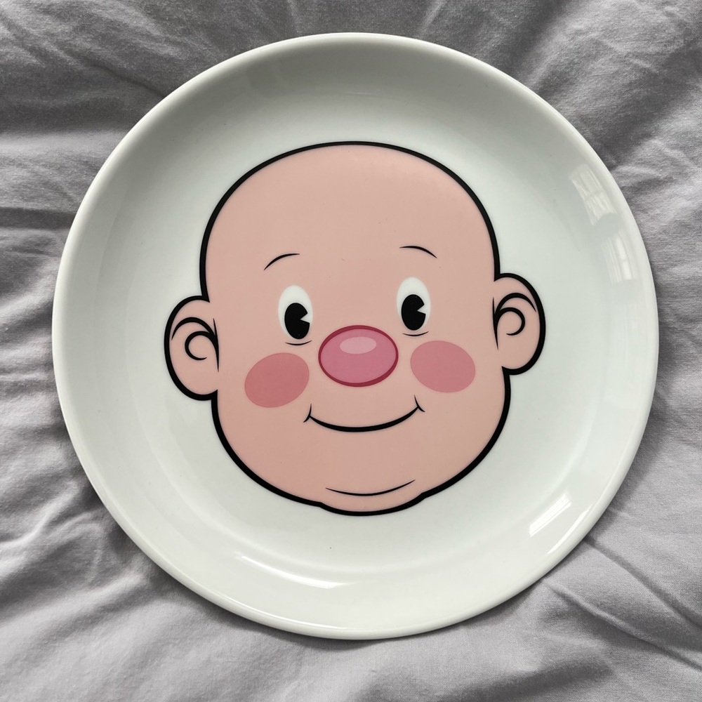 Fred plays with his food plate